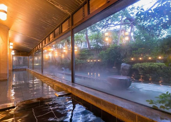 The relaxing, steamy waters of Awazu Onsen at Hoshi Ryokan in Ishikawa, overlooking the gardens.